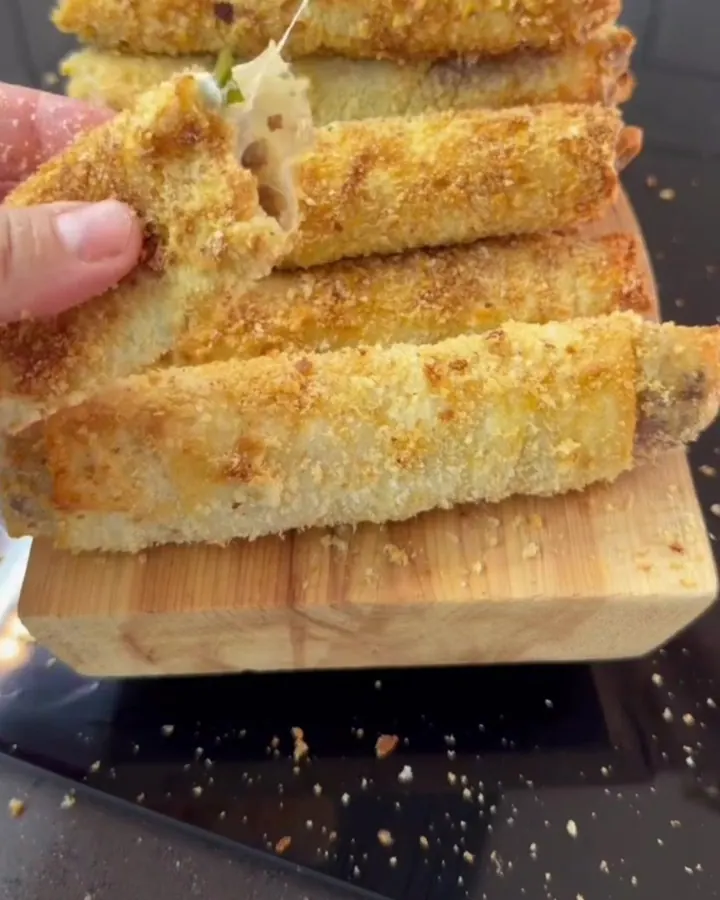 Crispy golden Turkish börek rolls on a parchment-lined baking sheet