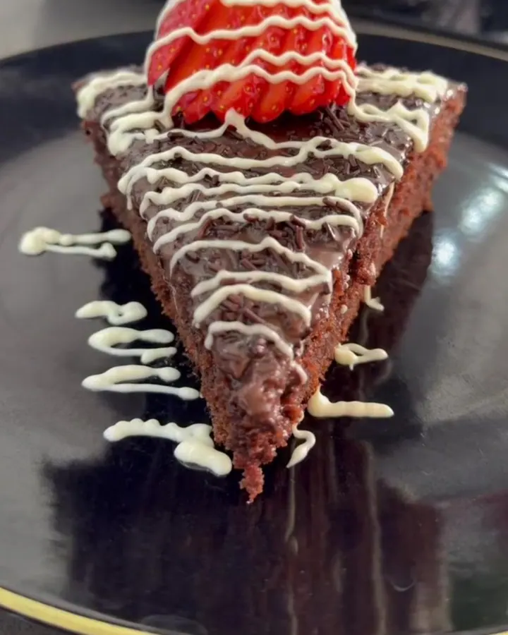 Stovetop skillet chocolate cake with ganache, sprinkles, strawberry, and white chocolate drizzle